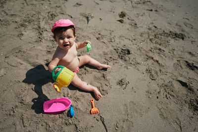 A baby playing with beach toys in the sand. vacation concept