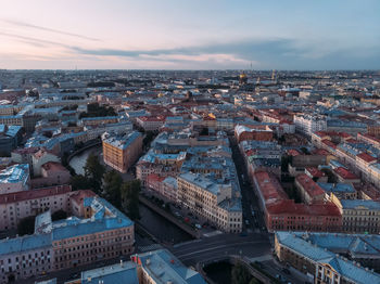 Aerial view of red and grey rooftops of saint petersburg. on the background st. isaac's cathedral