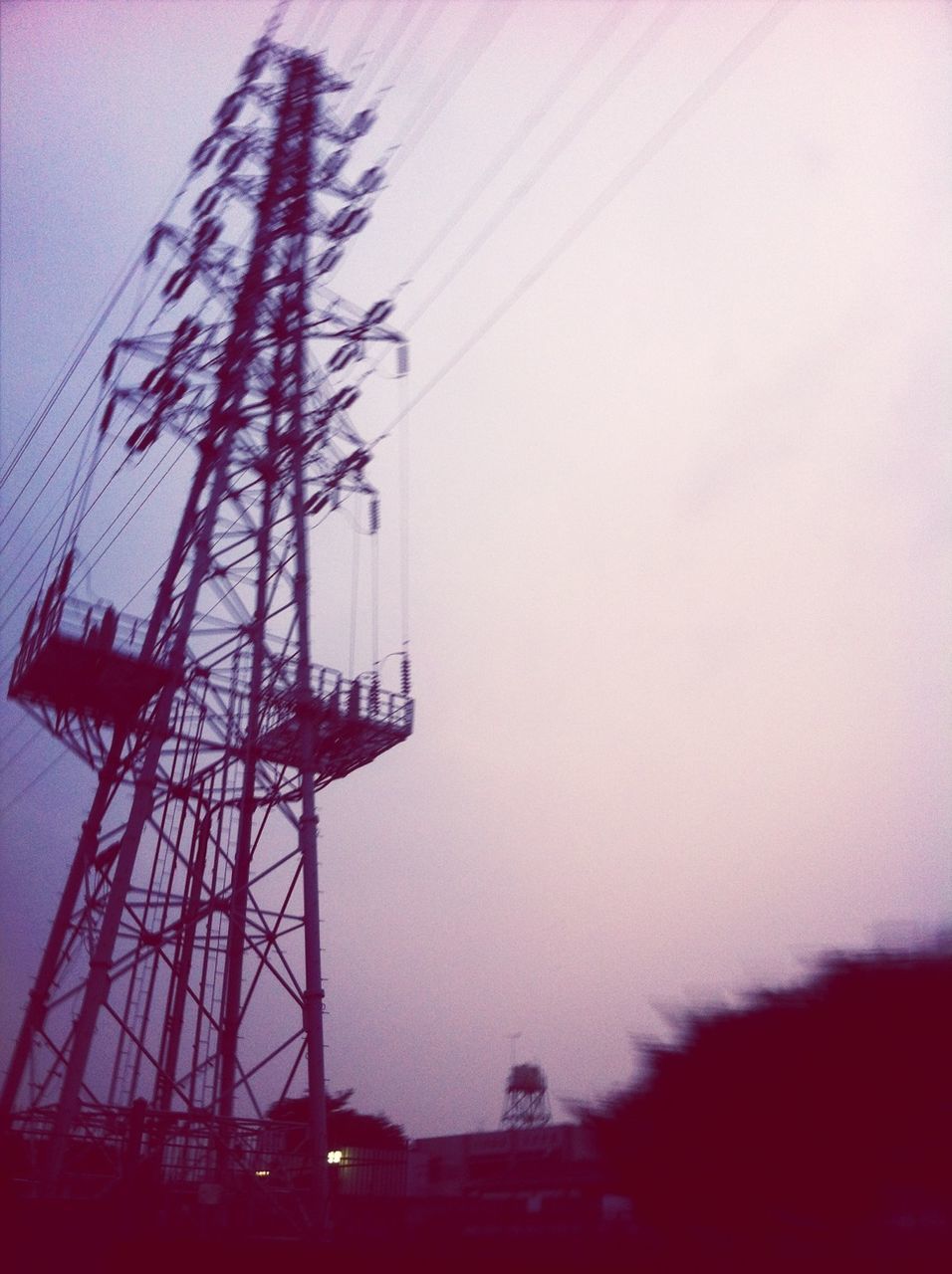 low angle view, electricity pylon, silhouette, power line, electricity, sky, clear sky, dusk, technology, built structure, building exterior, fuel and power generation, cable, power supply, connection, sunset, architecture, copy space, outdoors, no people
