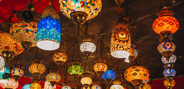 Low angle view of illuminated lanterns hanging at market stall