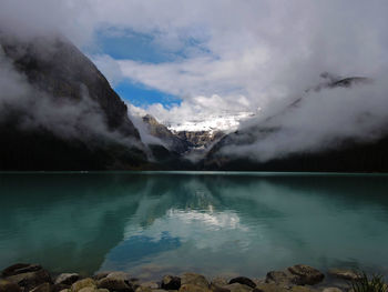 Scenic view of lake and mountains against sky