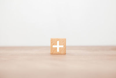 Close-up of wooden box on table against white background