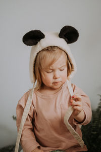 Toddler baby girl in funny hat with ears having fun