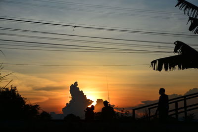 Silhouette birds against sky during sunset