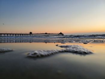 Scenic view of sea against clear sky during sunset