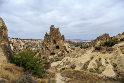 Rock formations on landscape against sky