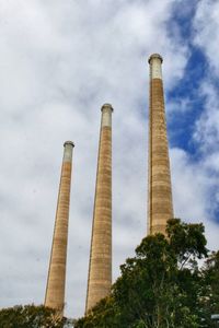 Low angle view of smoke stack against sky