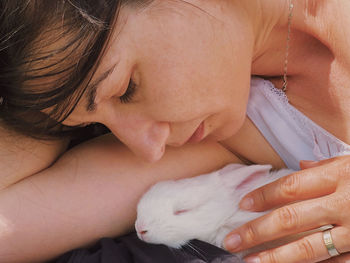 Close-up of woman holding white rabbit