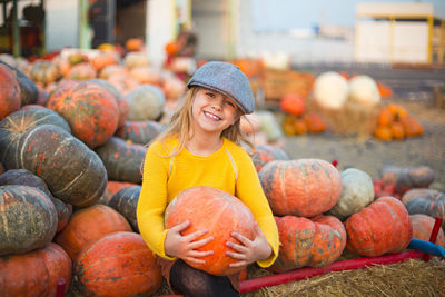 Portrait of a smiling young man with pumpkins