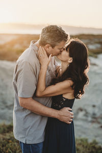 Husband and wife exchange romantic kiss at the bach