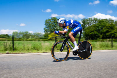 Man riding bicycle on road