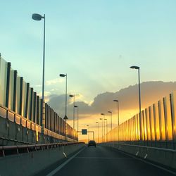 Road by bridge against sky in city