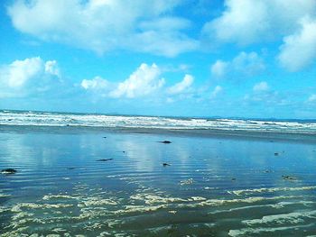 Scenic view of sea against cloudy sky