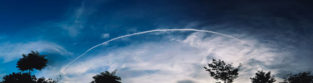 Low angle view of vapor trails in sky