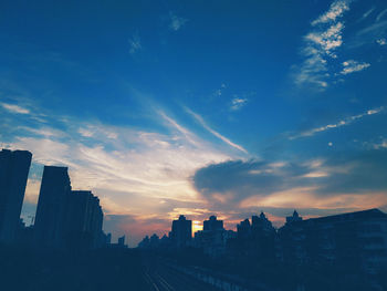 View of cityscape against cloudy sky