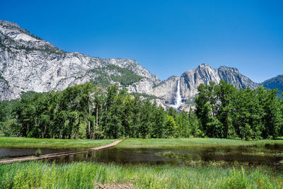 Scenic view of mountains against clear blue sky