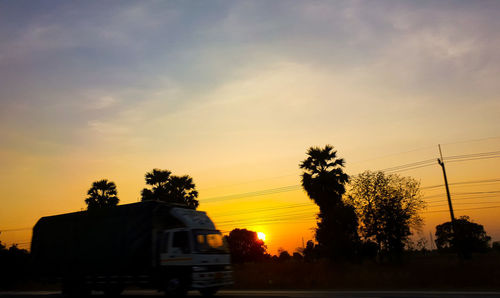 Silhouette trees against sky during sunset