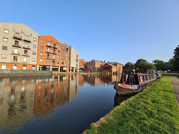 Canal amidst buildings against sky