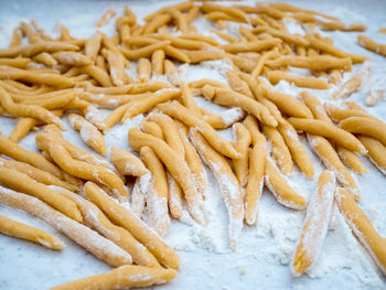 High angle view of dough with flour on table