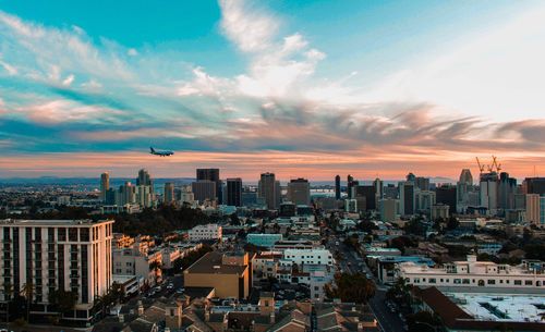 View of cityscape against cloudy sky