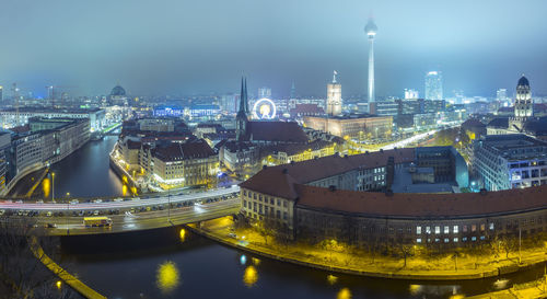 High angle view of city lit up at night