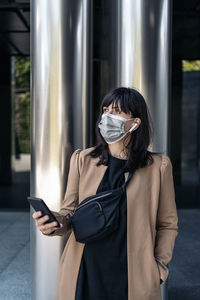 Midsection of woman using mobile phone