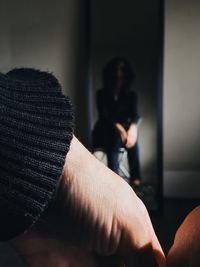 Reflection of woman in mirror at home