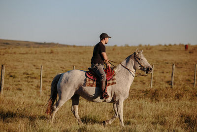 Man riding horse on field