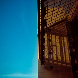 Low angle view of factory against clear blue sky