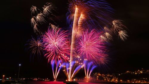 Low angle view of firework display at night