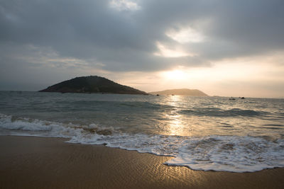 Scenic view of beach against sky during sunset