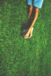 Low section of person standing on grassy field