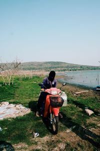 Rear view of man riding motorcycle