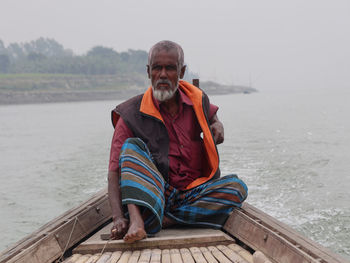 Boatman driving boat in the river padma, manikganj bangladesh