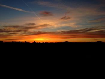 Silhouette landscape against sky during sunset