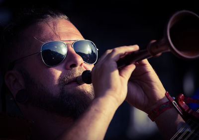 Portrait of man holding sunglasses