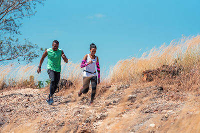 Full length of couple on land against sky