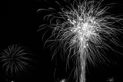 Low angle view of firework display at night
