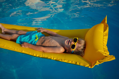 Low section of woman swimming in sea