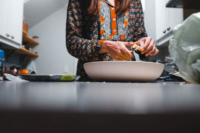Midsection of woman holding food at home