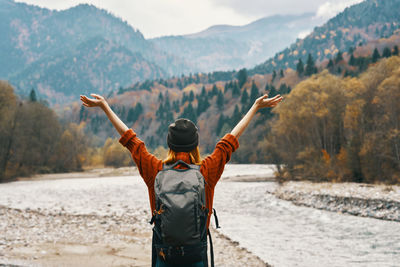 Rear view of man standing on shore