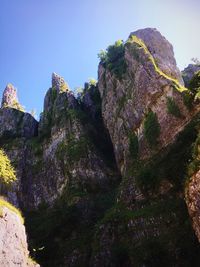 Low angle view of rock formation against sky