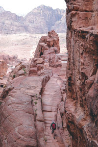 Rear view of man walking on rock