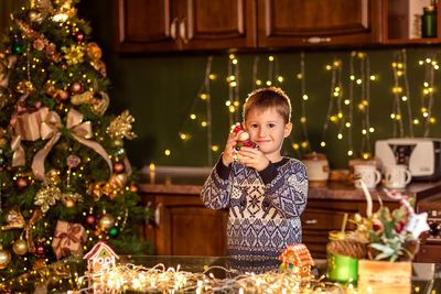 Portrait of woman holding christmas tree