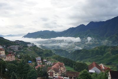 Townscape by mountains against sky