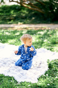 Boy sitting on field