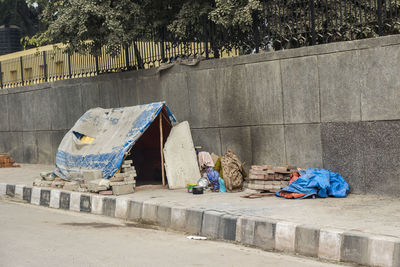 Comporary tent of unidentified homeless people on side of street in delhi, india