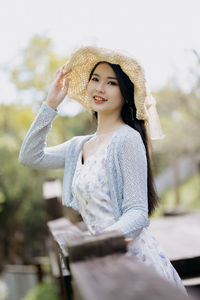 Portrait of young woman sitting on table