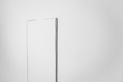 Low angle view of white wall against clear sky