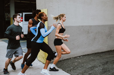 People running on road in city